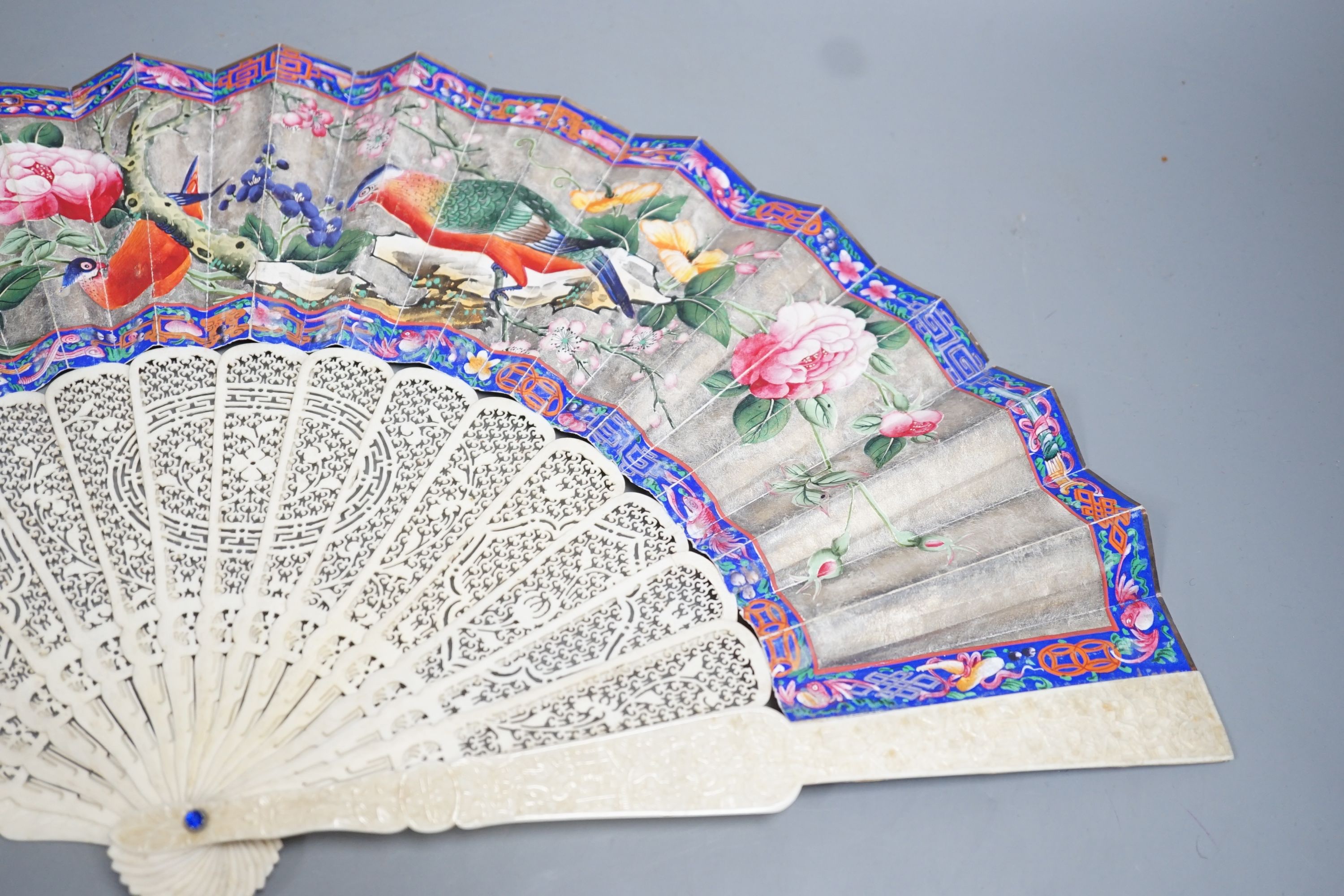 A 19th century Chinese export pierced ivory and painted paper leaf fan. 28cm long